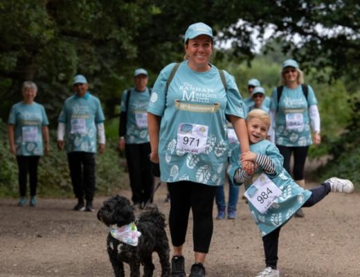 Family and a dog walking in the Banham Marsden March