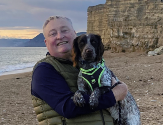 Malcolm Pearce at the beach with his dog 