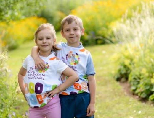 Two children wearing colourful Royal Marsden Cancer Charity running vests