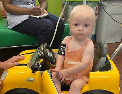 Lola in yellow toy car
