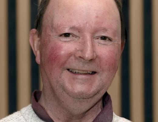 Headshot of a Royal Marsden patient in the Oak Cancer Centre. He is smiling and wearing a shirt with a knitted jumper