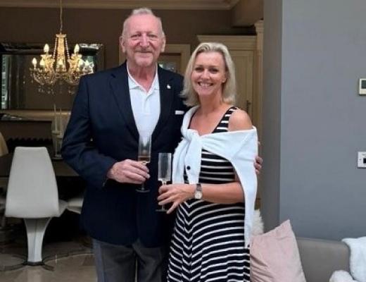 Alastair standing in a restaurant with his partner Jayne