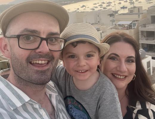 Tash by a harbour with her family in sunset